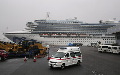 An ambulance leaves a port where the quarantined Diamond Princess cruise ship is docked, Feb. 16, 2020, in Yokohama, near Tokyo. (AP Photo/Jae C. Hong)