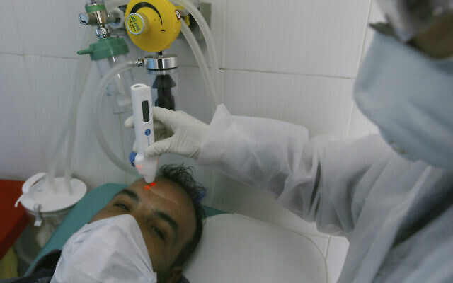 A man gets tested for COVID-19 in Algiers, Algeria, Wednesday, Feb. 26, 2020. (AP/Anis Belghoul)