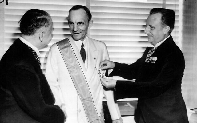 German diplomats award Henry Ford, center, Nazi Germany's highest decoration for foreigners, The Grand Cross of the German Eagle, in Detroit on July, 30, 1938, for his  service  to the Third Reich. Karl Kapp, German consul in Cleveland pins the medal while Fritz Heiler, left, German consul in Detroit shakes his hand. (AP Photo/file)
