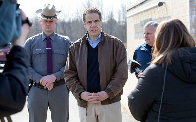 New York Gov. Andrew Cuomo, center, talks to reporters in front of the Sidney Albert Albany JCC after the building was evacuated due to an emailed bomb threat, February 24, 2020. (Mike Groll/Office of Gov. Andrew Cuomo via JTA)