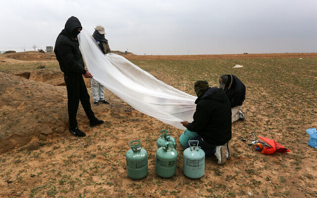 Illustrative: Palestinian men prepare a flammable object to be flown toward Israel, near the Israel-Gaza border east of Rafah in the southern Gaza Strip, on January 18, 2020. (Abed Rahim Khatib/ Flash90)