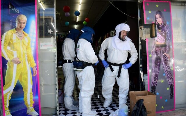 Workers disinfect a toy shop in Or Yehuda, after a man who works at the shop and returned from Italy tested positive for coronavirus February 28, 2020 (Flash90)
