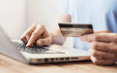Illustrative image of a person shopping with credit card and laptop (Poike; iStock by Getty Images)