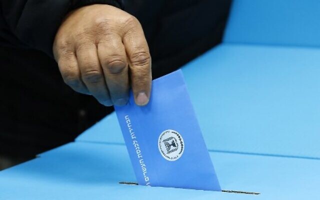 An Israeli man casts his ballot at a polling station in Rosh Haayin, on March 2, 2020 (Jack Guez/AFP)