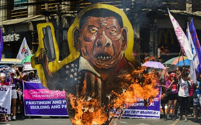 Filipino women burn an effigy of President Rodrigo Duterte as they stage a protest march in Manila on March 8, 2020 marking International Women's Day. (Maria TAN / AFP)