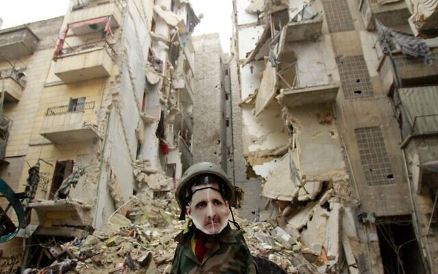 In this file photo taken on January 5, 2013, a dummy dressed up in army fatigue and a mask depicting Syrian President Bashar Assad is erected in the Salaheddine neighborhood of Aleppo, the scene of heavy fighting. (Photo by MAURICIO MORALES / AFP)