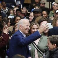 Democratic presidential candidate former US Vice President Joe Biden takes photos with supporters at a campaign event at Saint Augustine's University in Raleigh, North Carolina, February 29, 2020. (AP Photo/Gerry Broome)