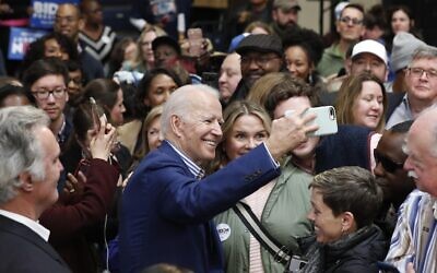 Democratic presidential candidate former US Vice President Joe Biden takes photos with supporters at a campaign event at Saint Augustine's University in Raleigh, North Carolina, February 29, 2020. (AP Photo/Gerry Broome)