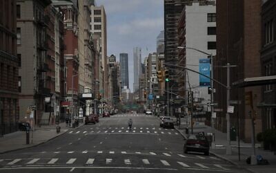 A cyclist rides his bicycle down the middle of a main road in downtown New York, March 22, 2020. (Wong Maye-E/AP)