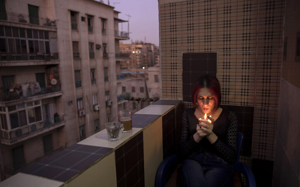 Egyptian transgender woman and activist Malak el-Kashif smokes a cigarette in the balcony of her apartment in Cairo, Egypt, October 28, 2019. (AP Photo/Nariman El-Mofty)