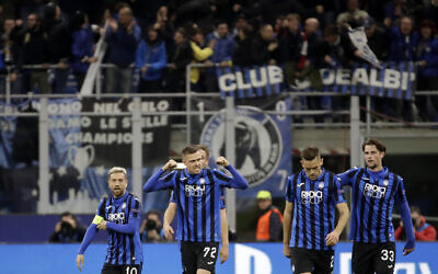 In this  file photo, Atalanta's Josip Ilicic, second left, celebrates with teammates after scoring his side's second goal during the Champions League round of 16, first leg, soccer match between Atalanta and Valencia at the San Siro stadium in Milan, Italy, February 19, 2020. (AP Photo/Luca Bruno, File)