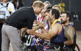 Britain's Prince Harry congratulates a member of the United States wheelchair basketball team after winning the gold medal in the finals during day eight of the Invictus Games in Sydney, Australia, October 27, 2018. (Chris Jackson/Pool Photo via AP)