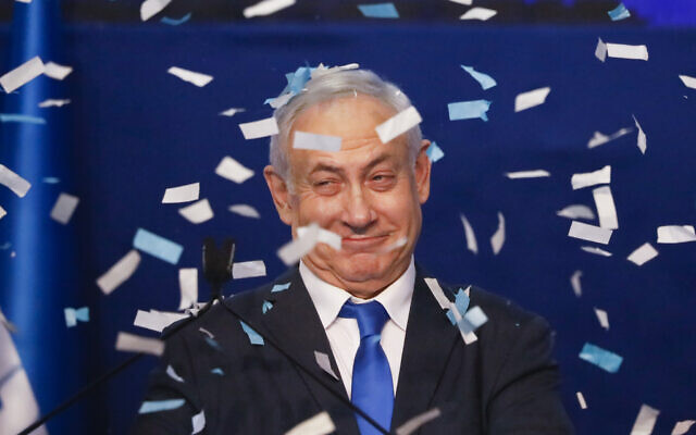 Israeli Prime Minister Benjamin Netanyahu smiles after first exit poll results for the Israeli elections at his party's headquarters in Tel Aviv,  March 3, 2020. (AP/Ariel Schalit)