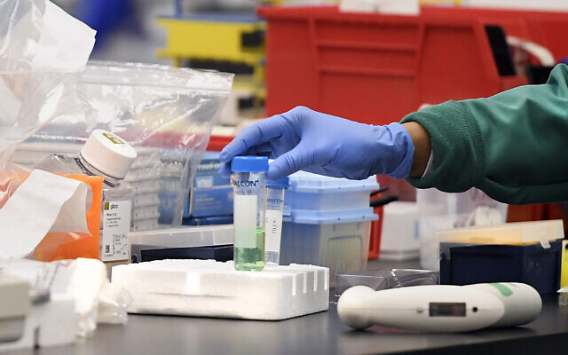 Illustrative: A researcher with a vial in a lab, March 12, 2020, in Meriden, Connecticut, amidst researching a vaccine for COVID-19. (AP Photo/Jessica Hill)