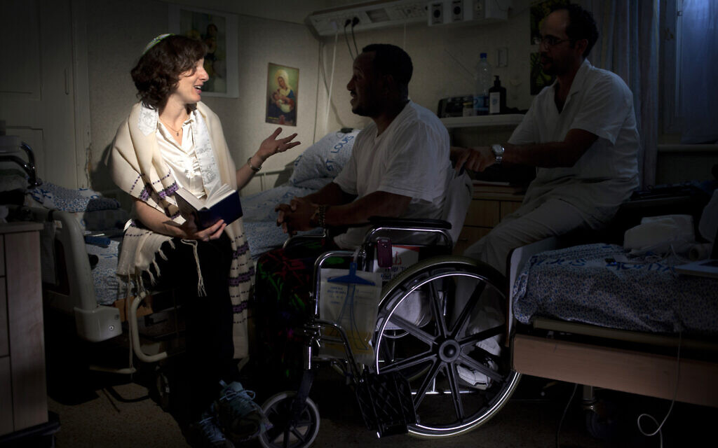 Illustrative: In this photo taken Thursday, June 20, 2013, Israeli Rabbi Miriam Berkowitz, left, of the Kashuvot organization for pastoral care, posed for a photo with a patient and nurse at a hospital in Jerusalem. (AP Photo/Sebastian Scheiner)
