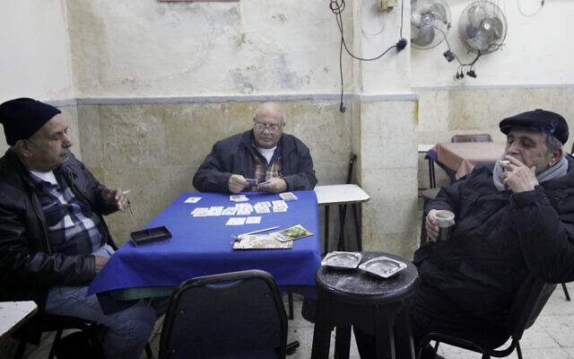 Illustrative: Elderly Israelis play cards at a coffeeshop in the Mahane Yehuda market in Jerusalem, January 10, 2012. (Miriam Alster/FLASH90/File)