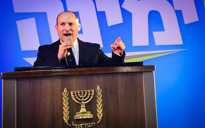 Yamina chairman Naftali Bennett gives a victory speech to supporters in Kfar Maccabiah after exit polls are released on March 2, 2020. (Flash90)