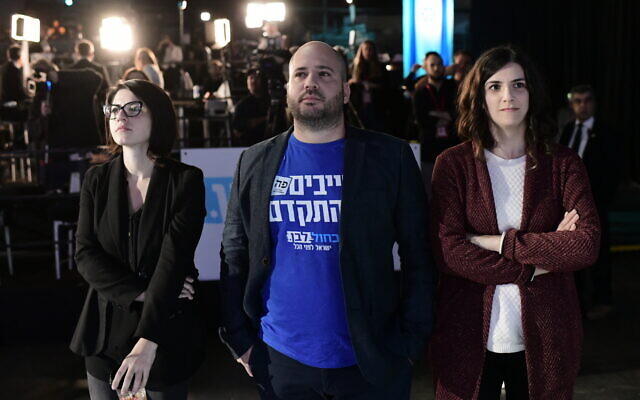 People react to the results of the demo polls at the Blue and White headquarters on elections night in Tel Aviv, on March 2, 2020. (Tomer Neuberg/Flash90 )