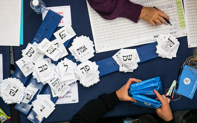 Officials count ballots from the elections at the Knesset in Jerusalem, March 4, 2020. (Olivier Fitoussi/Flash90)