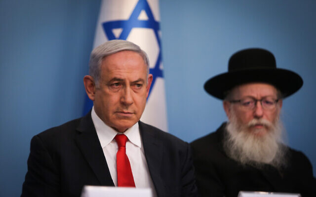 Prime Minister Benjamin Netanyahu, left, and Health Minister Yaakov Litzman hold a press conference about the coronavirus, at the Prime Ministers Office in Jerusalem on March 8, 2020. (Yonatan Sindel/Flash90)