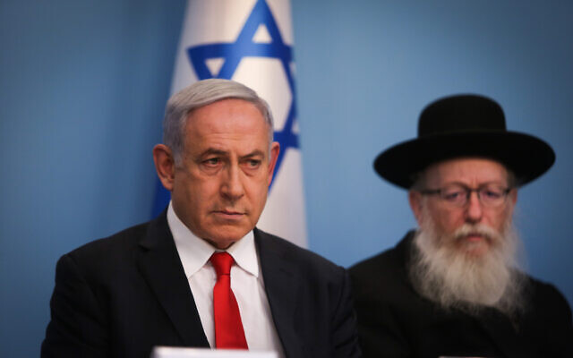 Prime Minister Benjamin Netanyahu, left, and then Health Minister Yaakov Litzman hold a press conference about the coronavirus, at the Prime Minister's Office in Jerusalem on March 8, 2020. (Yonatan Sindel/Flash90)