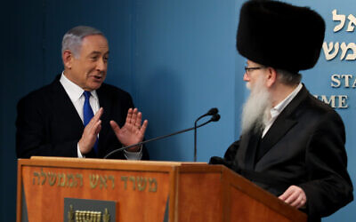 Prime Minister Benjamin Netanyahu (left) with Health Minister Yaakov Litzman, in Jerusalem, on March 11, 2020. (Flash90)