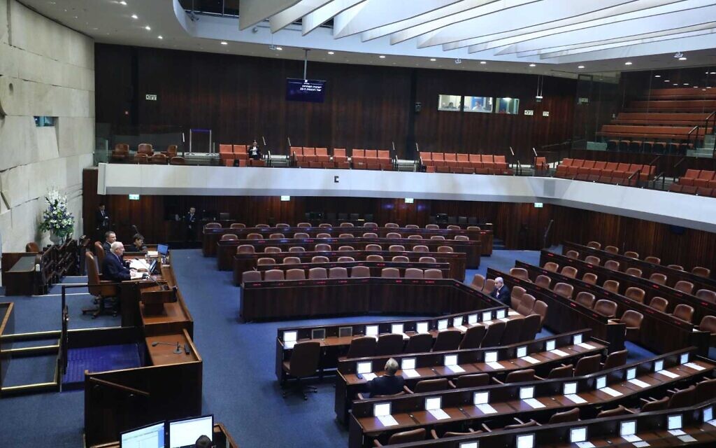 A nearly empty plenum, due to restrictions against the coronavirus, is seen at the swearing-in of the 23rd Knesset, March 16, 2020. (Gideon Sharon/Knesset Spokesperson)