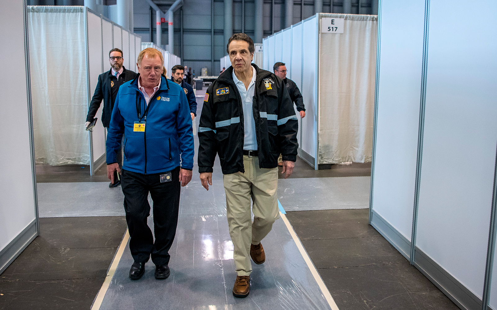 New York Govenror Andrew Cuomo, right, walks the corridor of a nearly completed makeshift hospital erected by the US Army Corps of Engineers at the Jacob Javits Convention Center in New York, March 27, 2020. (Darren McGee/Office of Governor Andrew M. Cuomo via AP)