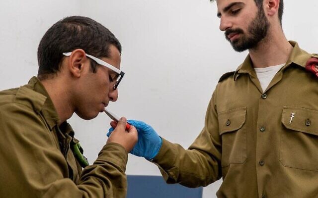 An IDF soldier has his temperature checked. (Photo: IDF Spokesperson's Unit)