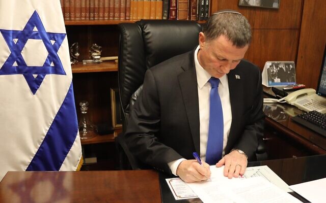 Knesset Speaker Yuli Edelstein signing an official response to the High Court over holding a vote to replace him, March 23, 2020. (Courtesy)