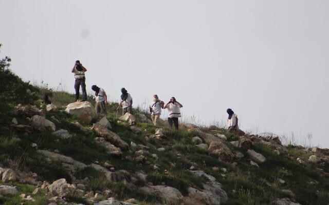 Settlers from Homesh hurl stones at Palestinians on March 26, 2020. (Yesh Din)