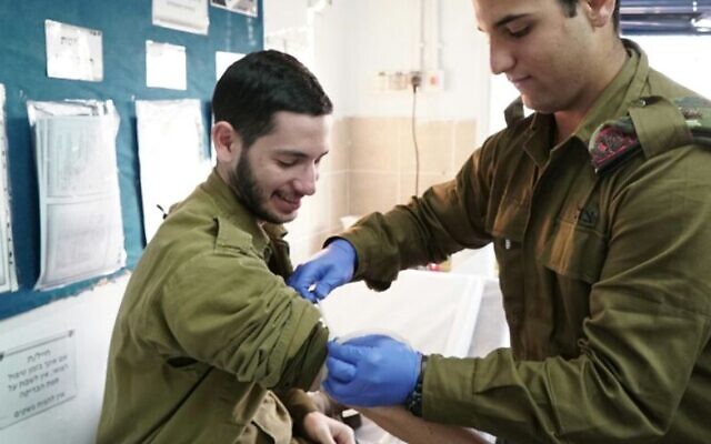 Illustrative: An IDF medic prepares to take blood from a soldier, in an undated photograph. (Israel Defense Forces)