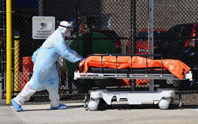 Medical staff move bodies from the Wyckoff Heights Medical Center to a refrigerated truck on April 2, 2020, in Brooklyn, New York. (Angela Weiss/AFP)