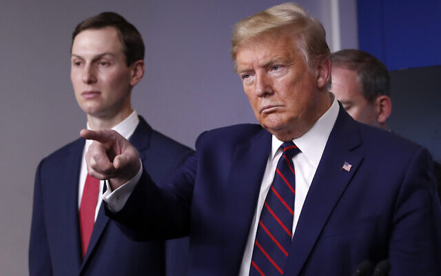 US President Donald Trump points to a reporter to ask a question as he speaks about the coronavirus in the James Brady Press Briefing Room of the White House, Thursday, April 2, 2020, in Washington, as White House adviser Jared Kushner listens. (AP Photo/Alex Brandon)