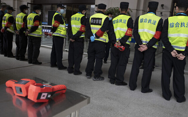 Security personnel armed with thermal imaging devices are briefed at the Hankou railway station on the eve of its resuming outbound traffic in Wuhan in central China’s Hubei province on April 7, 2020. (AP Photo/Ng Han Guan)