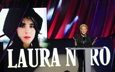 Bette Midler presents the late Laura Nyro for induction into the Rock and Roll Hall of Fame Saturday, April 14, 2012, in Cleveland. (AP Photo/Tony Dejak)