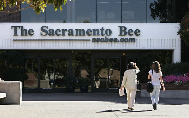In this Aug. 25, 2008, file photo, people walk into the Sacramento Bee newspaper building in Sacramento, California (AP Photo/Rich Pedroncelli, File)