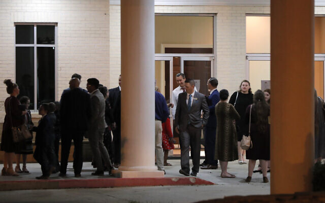 Pastor Tony Spell, center background, talks to congregants after an evening service at Life Tabernacle Church in Central, La., Tuesday, March 31, 2020. (AP/Gerald Herbert)