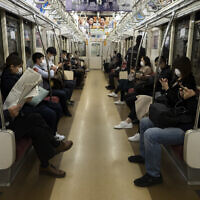 Commuters ride a train in Tokyo, April 7, 2020. (Jae C. Hong/AP)