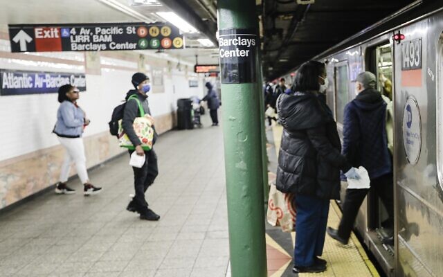 Patrons board a train while wearing masks at the Alantic Avenue station Tuesday, April 7, 2020, in the Brooklyn borough of New York (AP Photo/Frank Franklin II)
