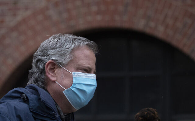 New York Mayor Bill de Blasio wears a mask while honoring healthcare workers at Brooklyn's Kings County Hospital Center at a ceremony during the coronavirus pandemic, April 24, 2020, in New York. (AP Photo/Mark Lennihan)