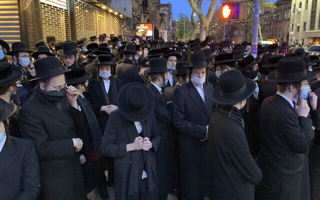 Hundreds of mourners gather in the Brooklyn borough of New York, Tuesday, April 28, 2020, to observe a funeral for Rabbi Chaim Mertz, a Hasidic Orthodox leader whose death was reportedly tied to the coronavirus.(Peter Gerber via AP)