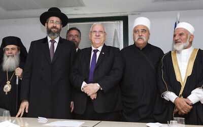 Illustrative: Greek Orthodox patriarch Theophilos III (L), Ashkenazi Chief Rabbi David Lau (2nd-L), then President-elect Reuven Rivlin (C), Druze spiritual leader Sheikh Muafek Tarif (2nd-R), and Union of Imams in Israel leader Sheikh Muhammad Kiwan, during a meeting of religious leaders at the offices of the Chief Rabbinate in Jerusalem, on July 9, 2014. (Flash90)