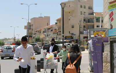 Residents of the mixed Modern Orthodox-Haredi neighborhood of Ramat Beit Shemesh Aleph on April 27, 2020. (Sam Sokol)