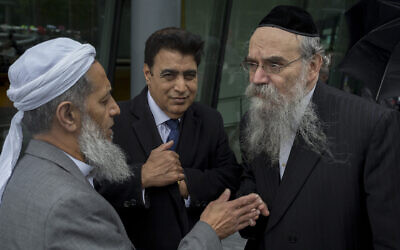 Rabbi Avrohom Pinter, right, speaks with other community leaders in London, June 5, 2017. (Richard Baker / In Pictures via Getty Images via JTA)