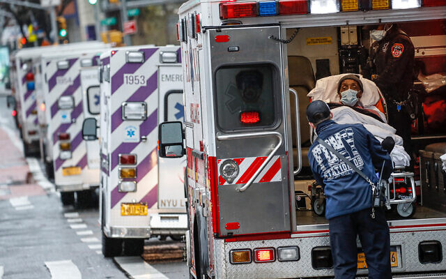 A patient arrives in an ambulance outside NYU Langone Medical Center in New York, April 13, 2020. (AP/John Minchillo)
