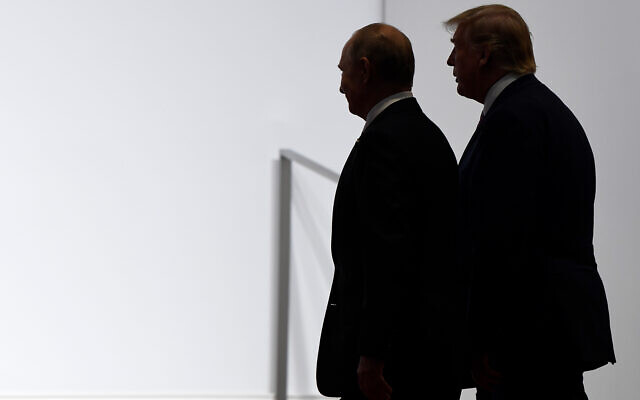 US President Donald Trump and Russian President Vladimir Putin walk to participate in a group photo at the G20 summit in Osaka, Japan, June 28, 2019. (AP/Susan Walsh, File)