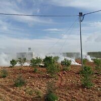 Tear gas fired as settlers and Palestinians fight near the West Bank town of Qusra on April 6, 2020. (Courtesy: Qusra Municipality)