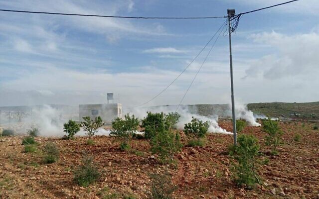 Tear gas fired as settlers and Palestinians fight near the West Bank town of Qusra on April 6, 2020. (Courtesy: Qusra Municipality)