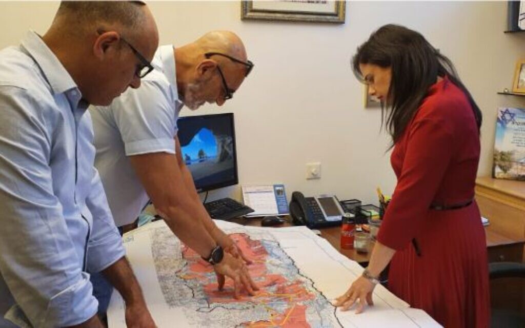 (De LR) El director del Consejo de Yesha, Yigal Dilmoni, el presidente David Elhayani muestran a Yamina MK Ayelet Agitó un mapa de Cisjordania basado en el plan Trump el 25 de mayo de 2020. (Cortesía)